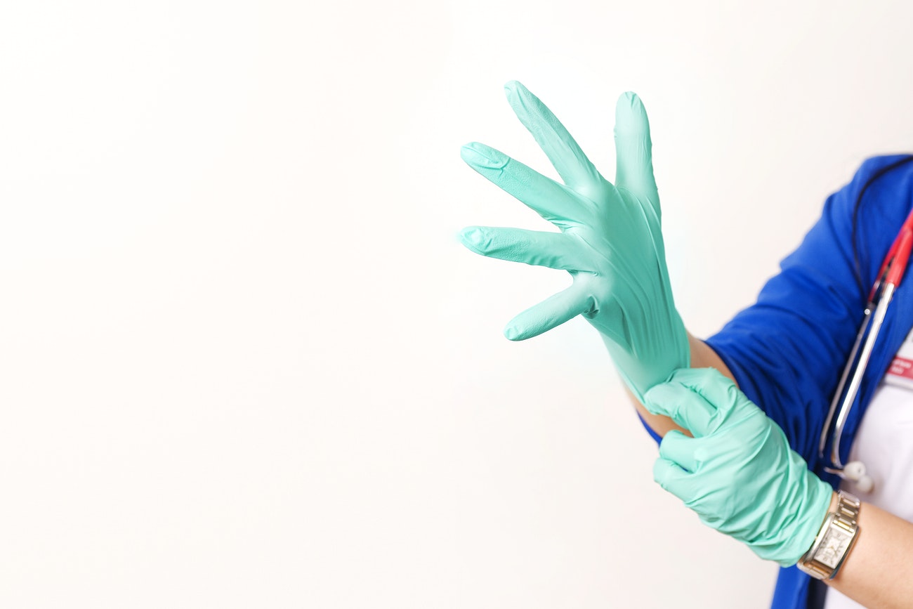 Maid putting on a cleaning glove